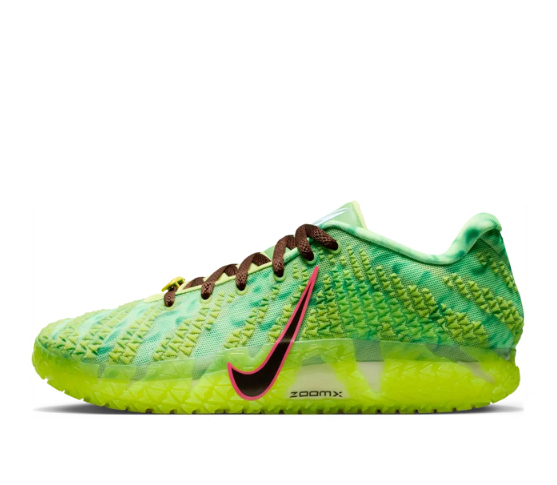 Side view of a green Nike low-top basketball shoe with ZoomX branding and a black Swoosh outlined in pink