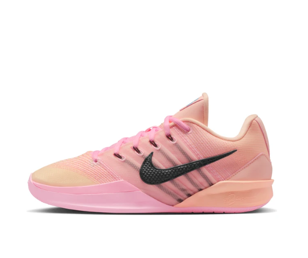 Side view of a tonal pink Nike low-top basketball shoe with a textured black Swoosh